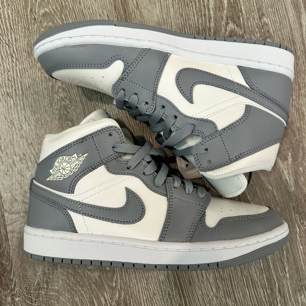 Women’s Air Jordan 1 Mid in Sail/Stealth-White. Size women’s 8 / EU 39